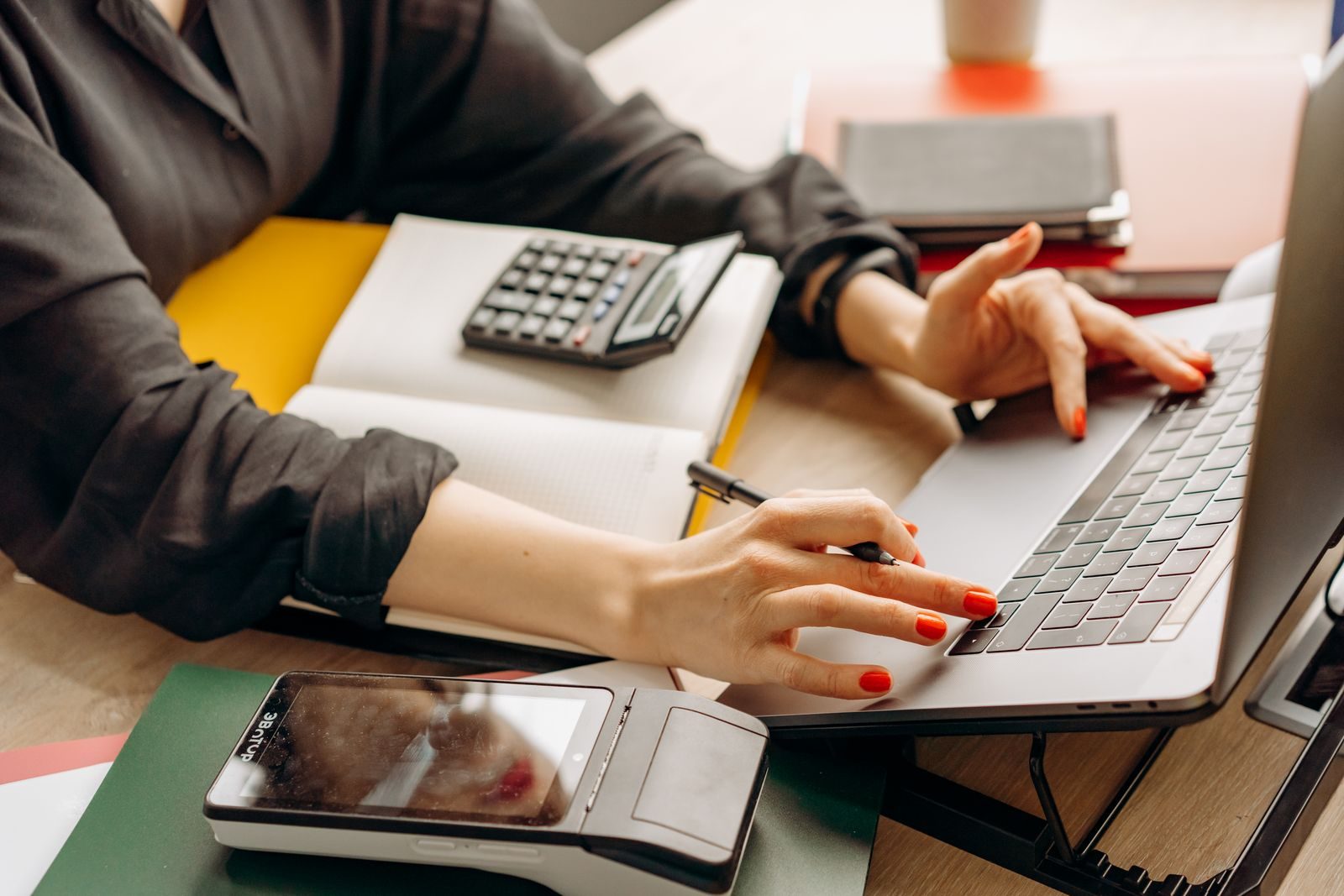 Portátil, datáfono y calculadora en un escritorio de facturación